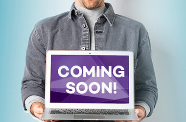 Person holding sign that say, coming soon